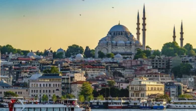 Turkiye Istanbul Cruise Ships And Ferry Sailing On The Bosphorus With The Suleymaniye Mosque In The Background At Sunset